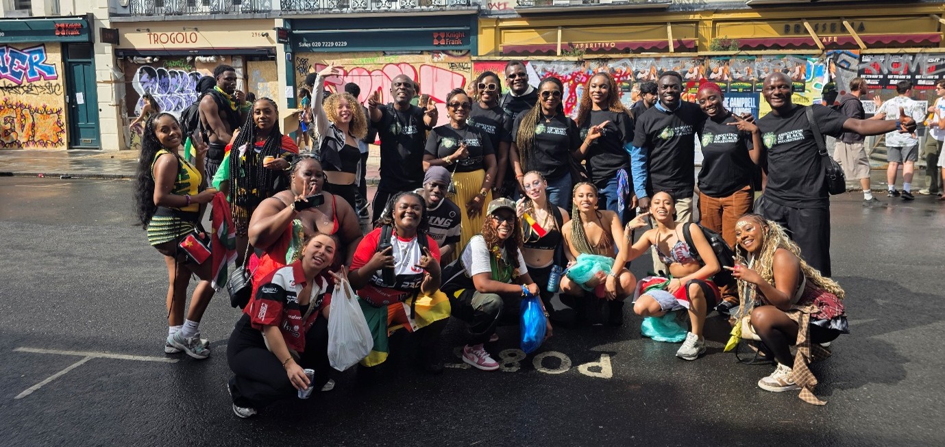 Group of people posing for a group shot on streets of London during Notting Hill Carnival