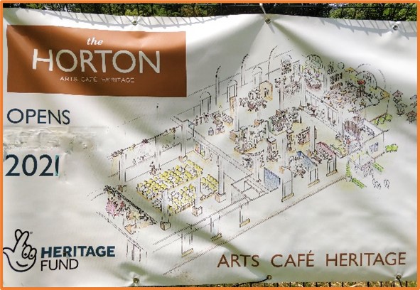 A large banner showing an artist's rendering of what the inside might look like once the building is finished. Underneath it says: arts, cafe, heritage.