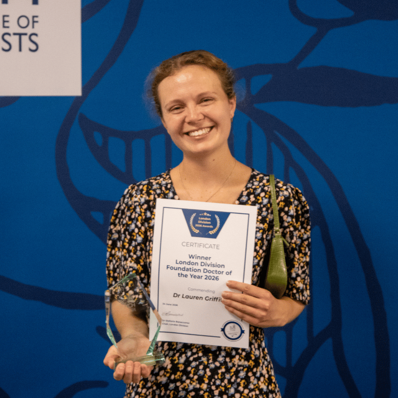Dr Lauren Griffiths holding a certificate for the foundation doctor of the year and  a prize