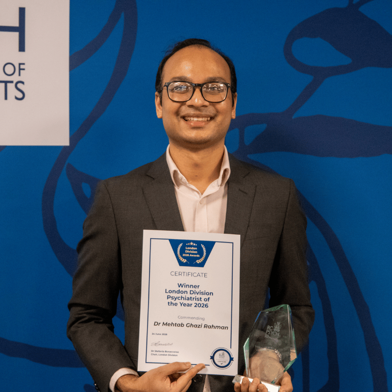 Mehtab Ghazi Rahman holding an award and certificate for winning the psychiatrist of the year at the london division awards