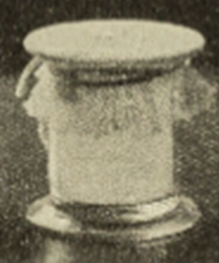 Black and white photo of a jar with fabric tied over the top.