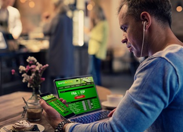 man gambling on phone 1320x1122