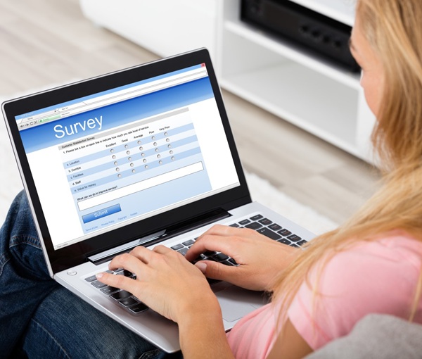 Woman completing survey on a computer